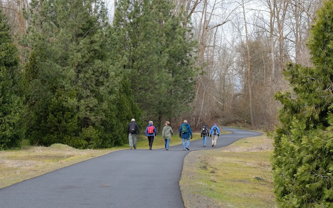 A small group walking together on a paved trail